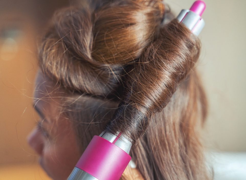 Woman curling her hair