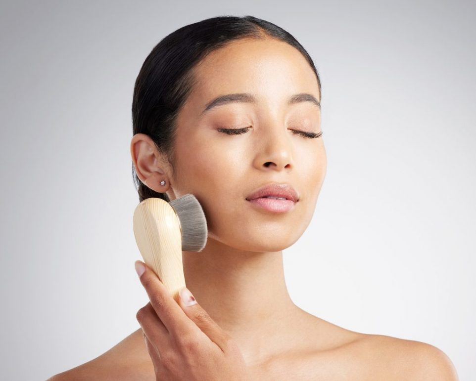 woman dry brushing her face