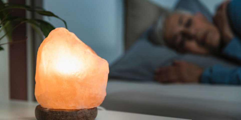 Mature Woman Sleeping with a Himalayan Salt Lamp in Bedroom