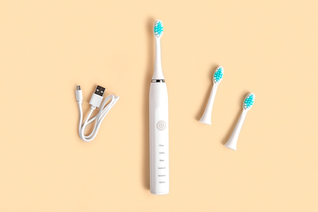 Best Electric Toothbrush. Top View, Flat Lay, Copy Space. Dental Care Supplies on Beige Pastel Studio Background. Oral Hygiene, Gum Health, Healthy Teeth. Modern Dental Ultrasonic Vibration Tooth Brush. sonic smart technology. bleaching