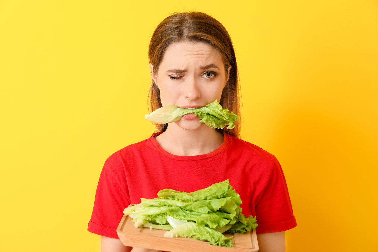 woman eating leafy greens