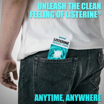 A man with Listerine mouthwash tablets visible in the back pocket of his jeans.